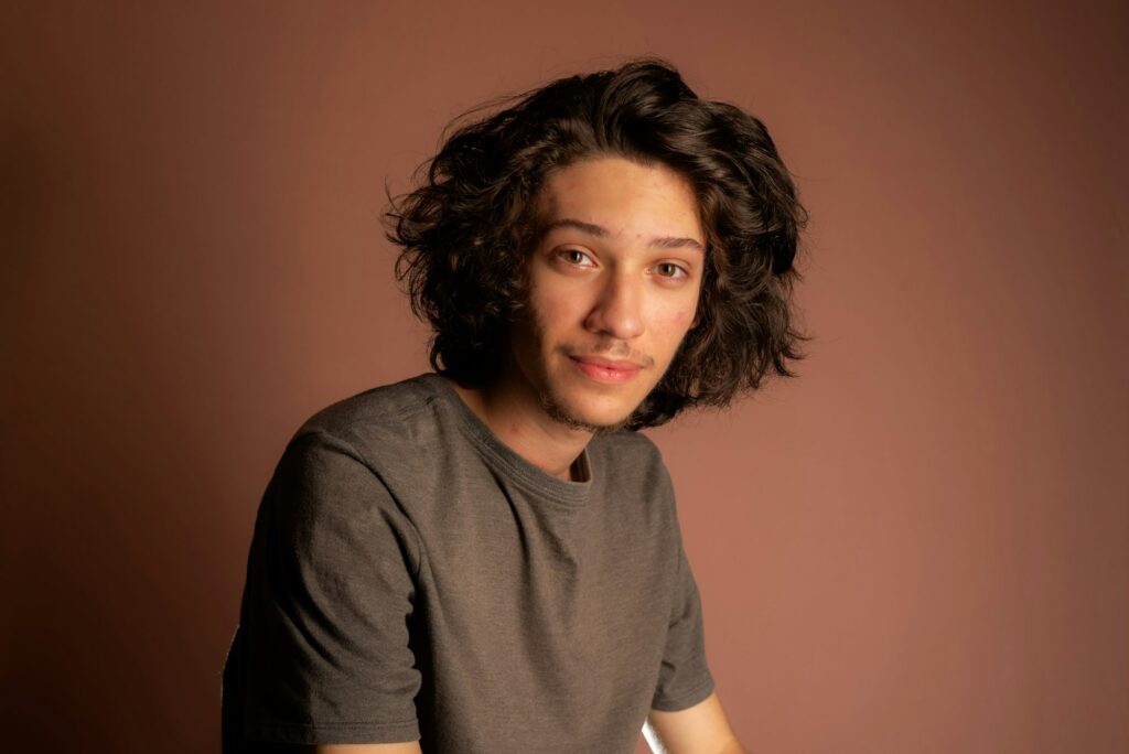 Young Caucasian male wearing casual clothing casually relaxing on a chair